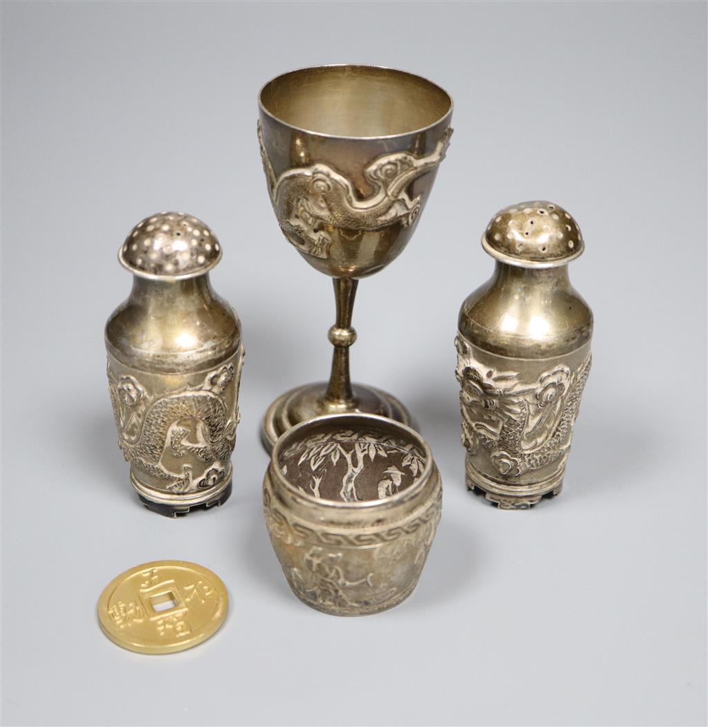 A pair of Chinese white metal pepperettes, 7cm, a similar salt, small goblet and a coin.